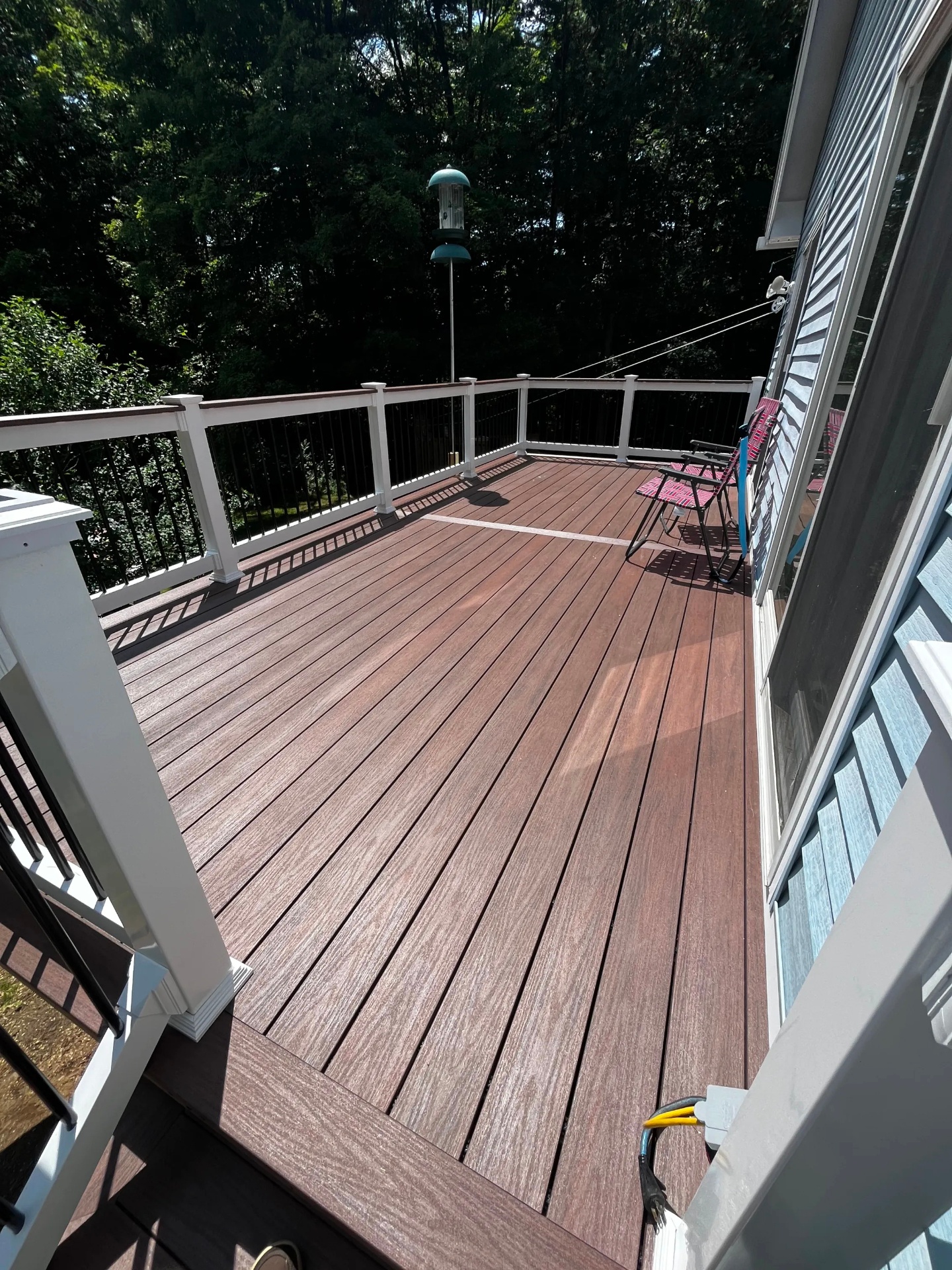 Top-down view of the finished Wolf composite deck floor showing multi-tonal brown board color and picture-frame border in Nottingham, NH